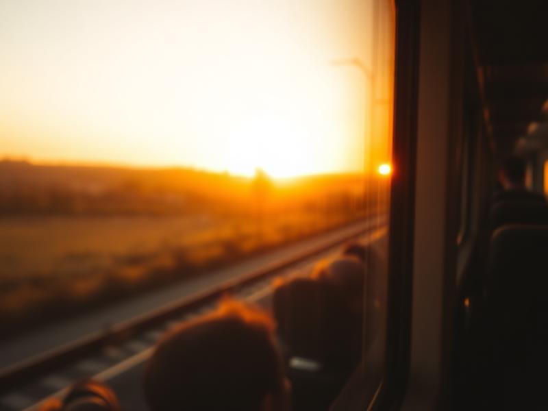 Golden hour view from a train window of a blurred European countryside